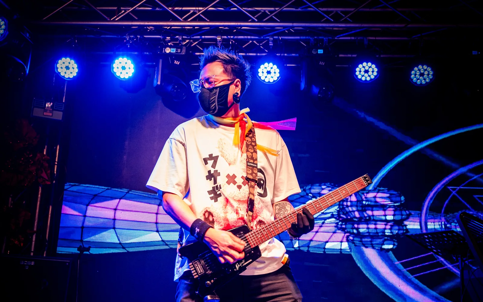 Guitarist performing under blue stage lights at Paragon Club, Cheras